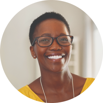 A smiling woman wearing glasses and a yellow top